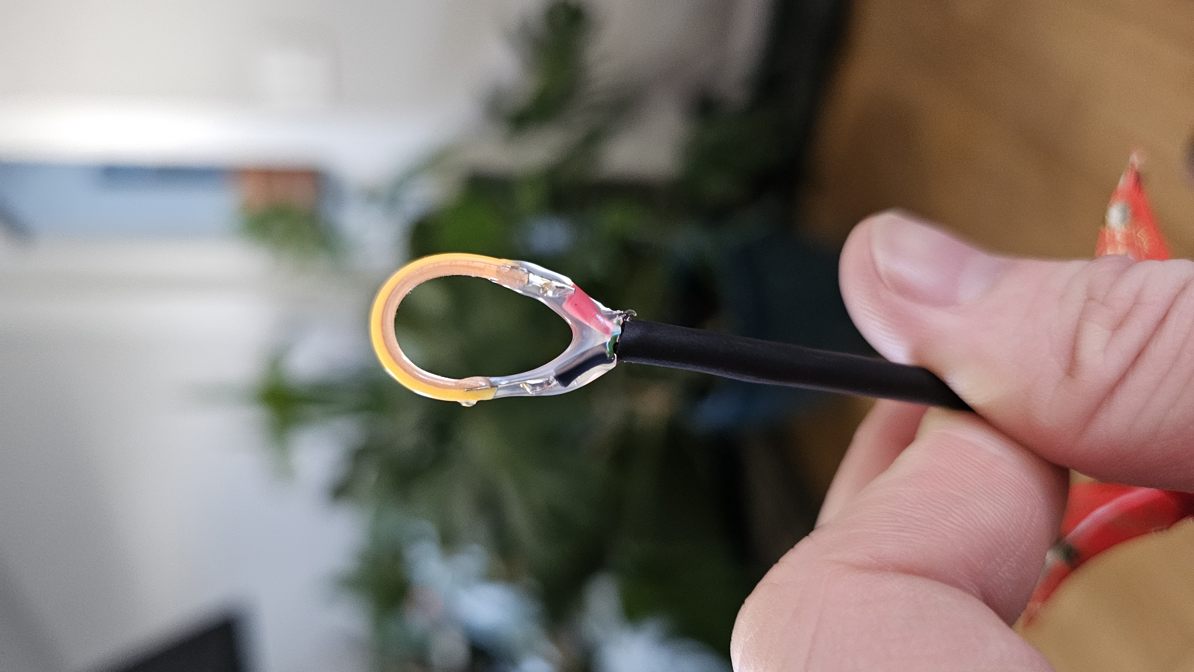 Soldered LED filament with hot glue stress relief